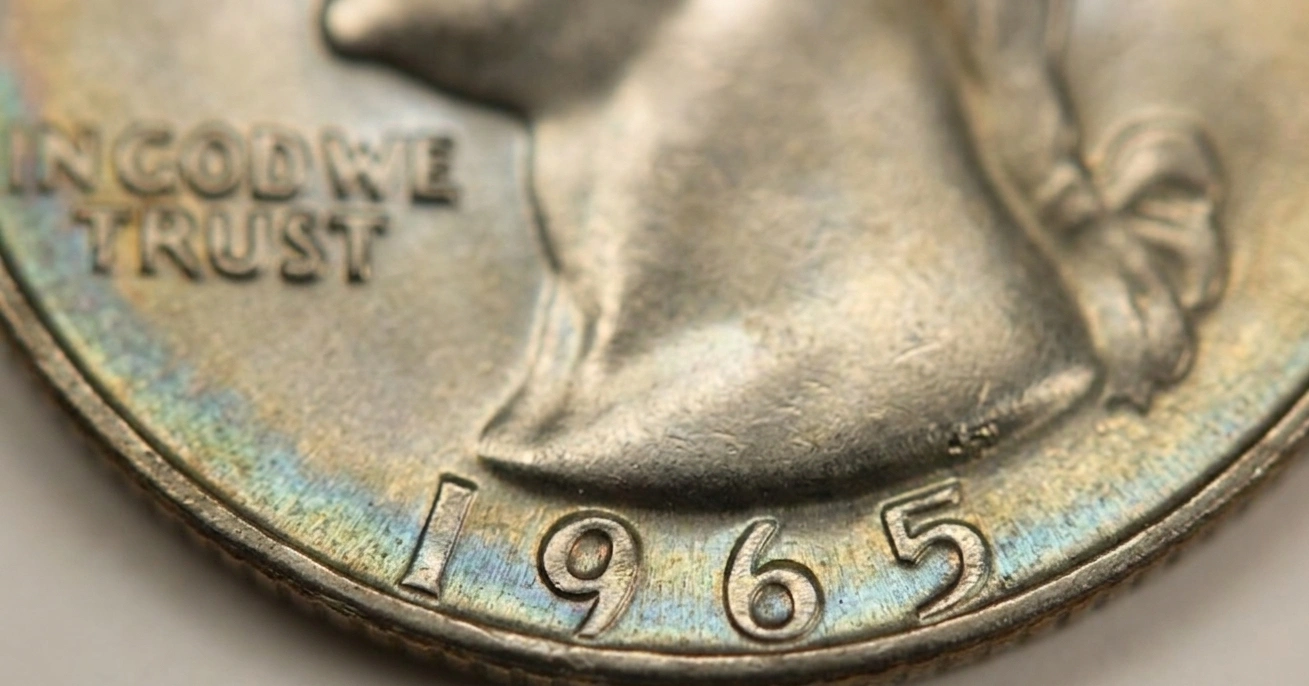A 1965 quarter coin in macro close-up showing date clearly